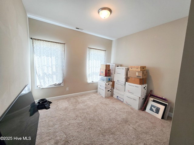 interior space featuring carpet floors, baseboards, and visible vents