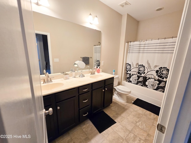 full bath with a sink, double vanity, toilet, and visible vents
