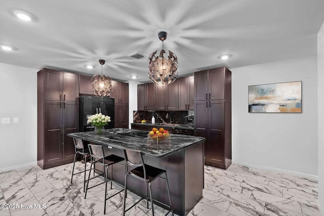1718 Highland Dr, Washington, NC 27889 - kitchen with baseboards, marble finish floor, a breakfast bar area, and recessed lighting