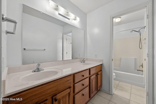 bathroom with tile patterned floors, toilet, double vanity, and shower / tub combination