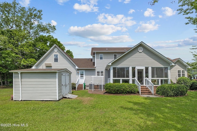 back of property featuring a sunroom, a shed, an outbuilding, and a lawn