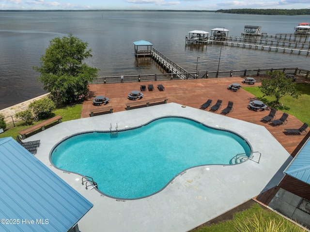 view of pool featuring a water view and fence