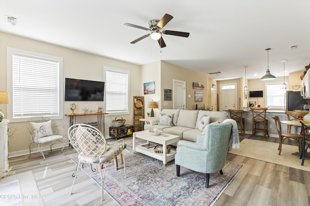 326 Starfish Ln, Sneads Ferry, NC 28460 - living area featuring light wood-style flooring, baseboards, a ceiling fan, and visible vents