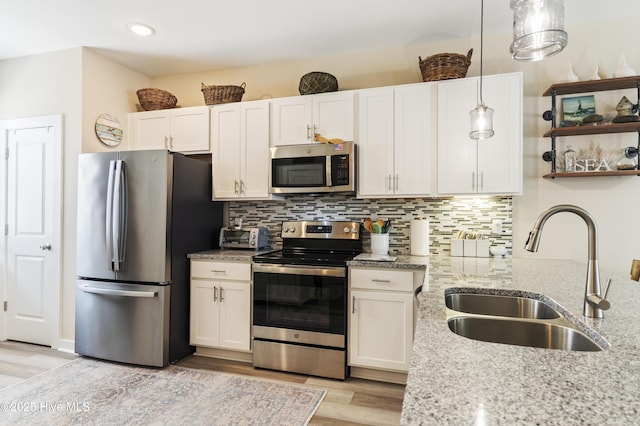 326 Starfish Ln, Sneads Ferry, NC 28460 - kitchen with light stone countertops, white cabinets, appliances with stainless steel finishes, and a sink