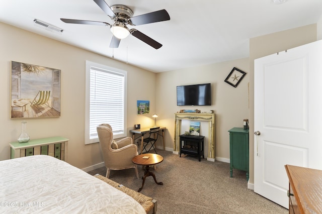 326 Starfish Ln, Sneads Ferry, NC 28460 - carpeted bedroom with a wood stove, baseboards, ceiling fan, and visible vents