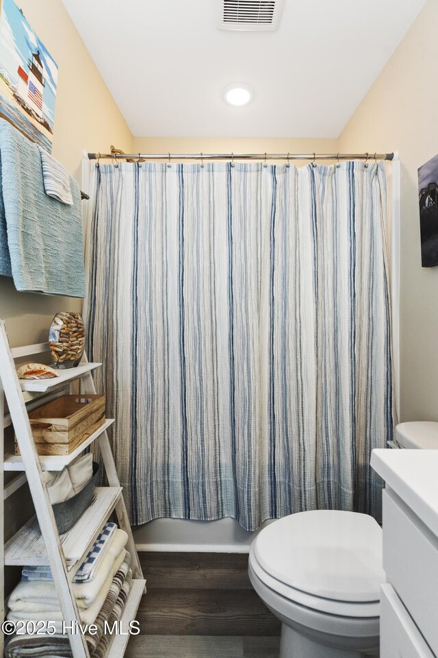 326 Starfish Ln, Sneads Ferry, NC 28460 - bathroom with toilet, wood finished floors, visible vents, shower / bathtub combination with curtain, and vanity