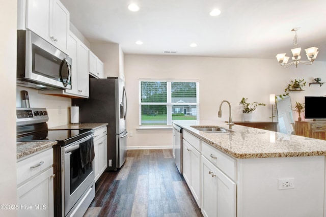 kitchen featuring a notable chandelier, a sink, white cabinetry, dark wood-type flooring, and appliances with stainless steel finishes