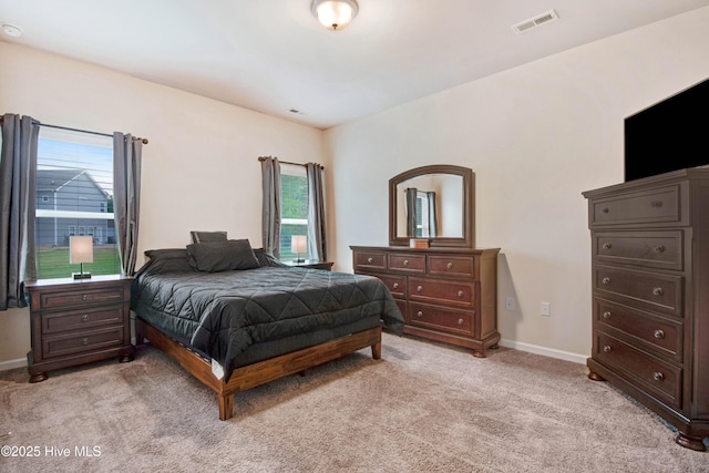 bedroom with light colored carpet, multiple windows, visible vents, and baseboards