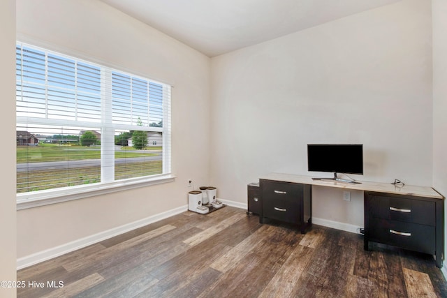 unfurnished office featuring dark wood-style flooring and baseboards