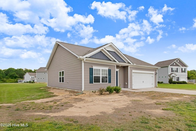 view of front facade with a front yard, concrete driveway, an attached garage, and board and batten siding