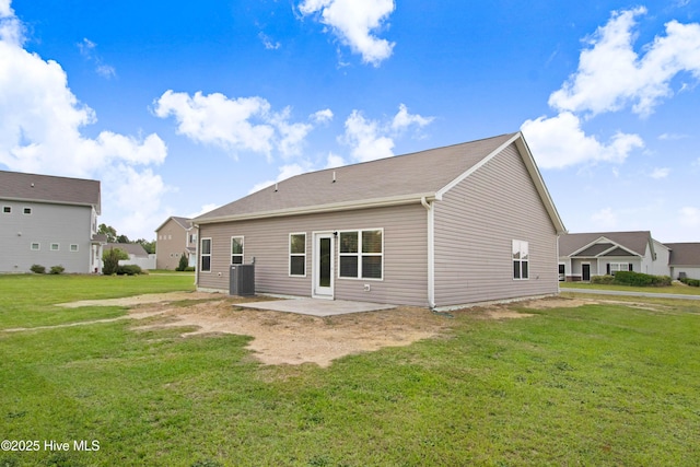 back of house featuring a yard, a patio area, and central AC