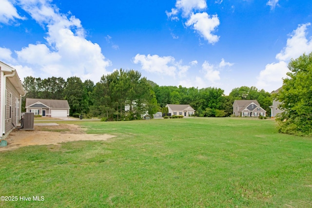 view of yard with cooling unit and a detached garage