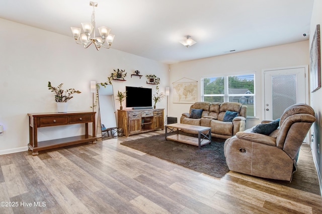 living room featuring an inviting chandelier and wood finished floors