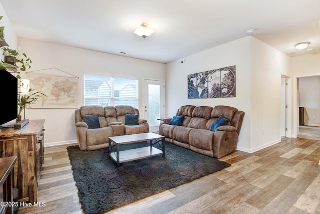 living room with baseboards and wood finished floors