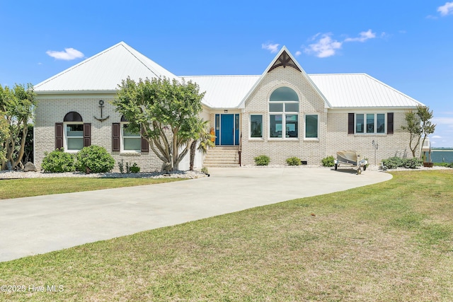 515 Blue Heron Dr, Newport, NC 28570 - ranch-style house with brick siding, a front yard, and metal roof