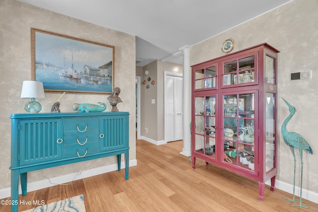 515 Blue Heron Dr, Newport, NC 28570 - hallway featuring wood finished floors, ornate columns, and baseboards