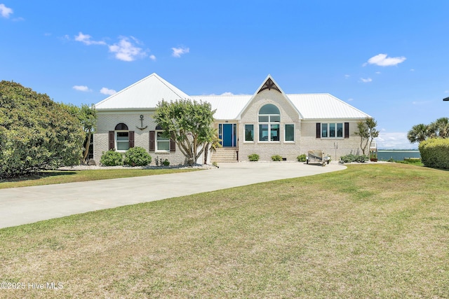 515 Blue Heron Dr, Newport, NC 28570 - view of front facade featuring brick siding, a front yard, and metal roof