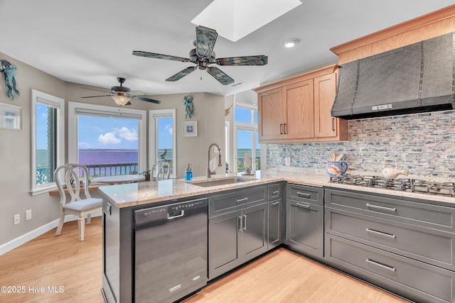 515 Blue Heron Dr, Newport, NC 28570 - kitchen with dishwasher, a sink, wall chimney range hood, stainless steel gas cooktop, and a peninsula