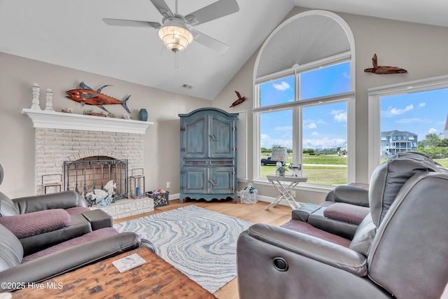 515 Blue Heron Dr, Newport, NC 28570 - living room featuring high vaulted ceiling, ceiling fan, light wood finished floors, and a brick fireplace