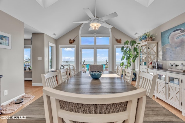 515 Blue Heron Dr, Newport, NC 28570 - dining space with a ceiling fan, healthy amount of natural light, light wood finished floors, a water view, and high vaulted ceiling