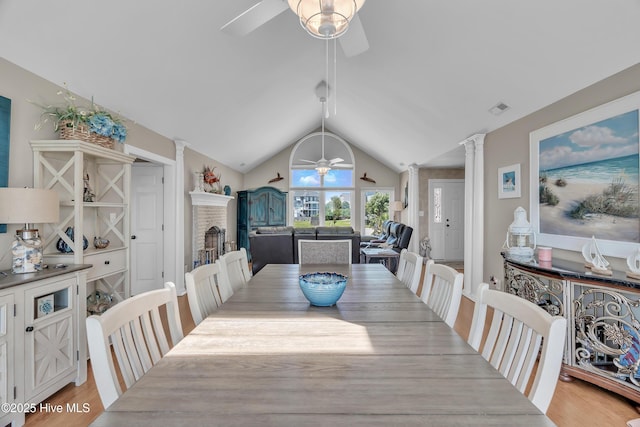 515 Blue Heron Dr, Newport, NC 28570 - dining area featuring ceiling fan, ornate columns, vaulted ceiling, and light wood-style floors