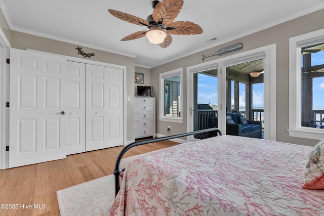 515 Blue Heron Dr, Newport, NC 28570 - bedroom featuring wood finished floors, access to exterior, ornamental molding, a closet, and ceiling fan