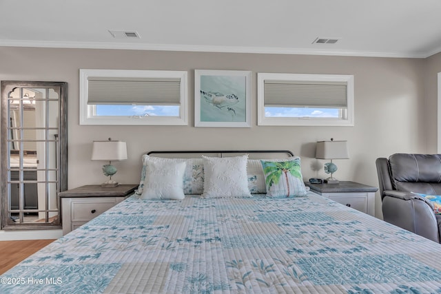 515 Blue Heron Dr, Newport, NC 28570 - bedroom featuring multiple windows, ornamental molding, and wood finished floors
