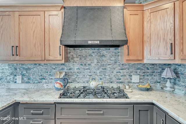 515 Blue Heron Dr, Newport, NC 28570 - kitchen with wall chimney range hood, black gas cooktop, gray cabinetry, and tasteful backsplash