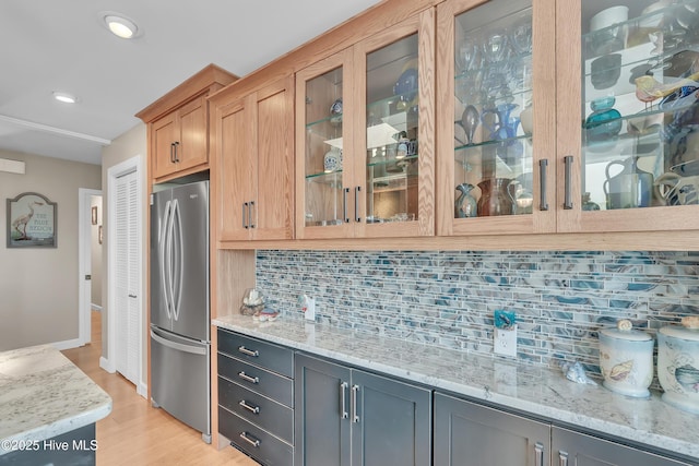 515 Blue Heron Dr, Newport, NC 28570 - kitchen featuring freestanding refrigerator, light stone countertops, light wood finished floors, glass insert cabinets, and recessed lighting