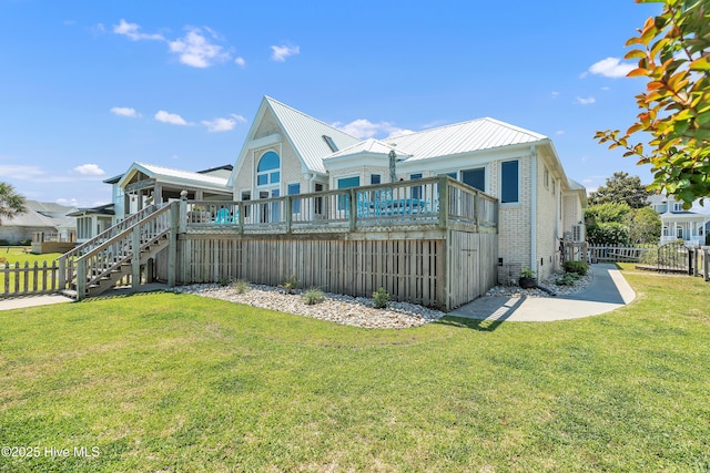 515 Blue Heron Dr, Newport, NC 28570 - rear view of house featuring stairs, a wooden deck, brick siding, and metal roof
