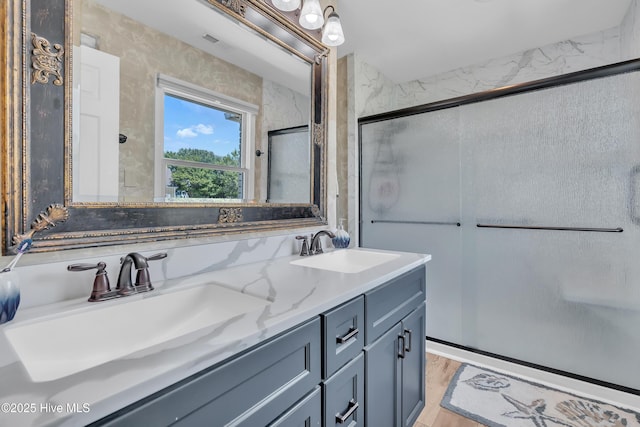 515 Blue Heron Dr, Newport, NC 28570 - bathroom with double vanity, a stall shower, and wood finished floors