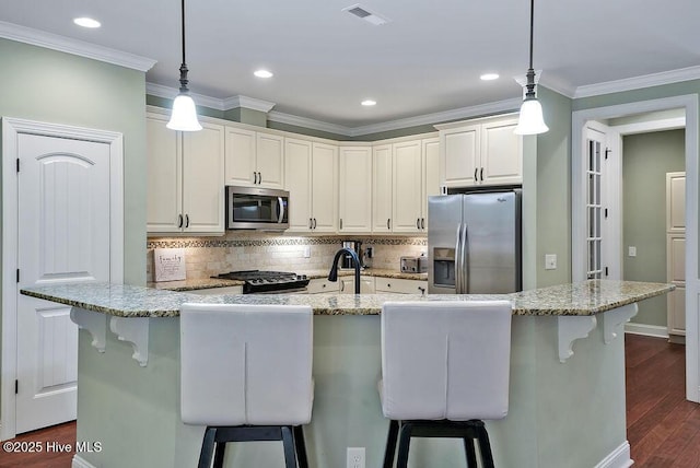 2225 Umstead Ln, Leland, NC 28451 - kitchen with stainless steel appliances, a kitchen breakfast bar, dark wood finished floors, backsplash, and light stone counters