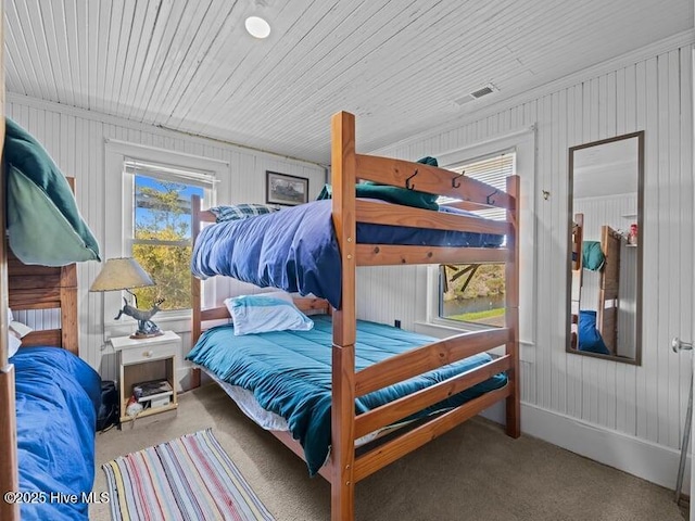 carpeted bedroom featuring visible vents
