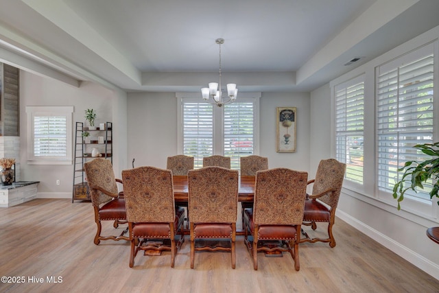 237 Pine Village Dr, Rocky Point, NC 28457 - dining space featuring light wood-type flooring, plenty of natural light, a chandelier, and a raised ceiling