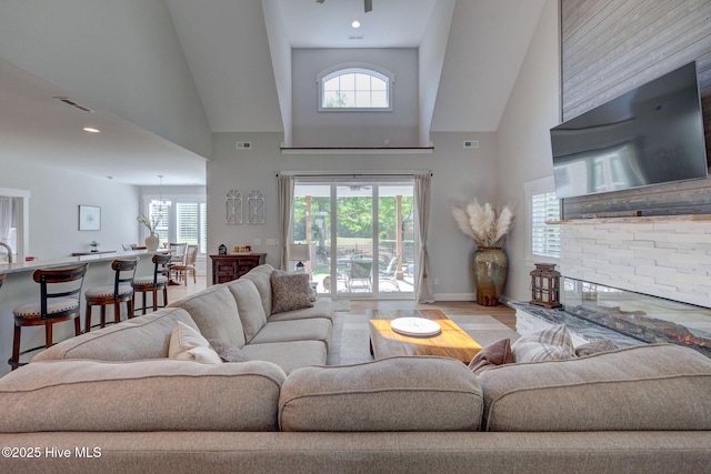 237 Pine Village Dr, Rocky Point, NC 28457 - living room with high vaulted ceiling, healthy amount of natural light, and wood finished floors