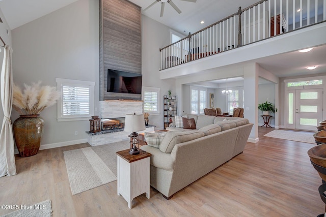 237 Pine Village Dr, Rocky Point, NC 28457 - living area featuring high vaulted ceiling, a multi sided fireplace, plenty of natural light, light wood-style floors, and ceiling fan