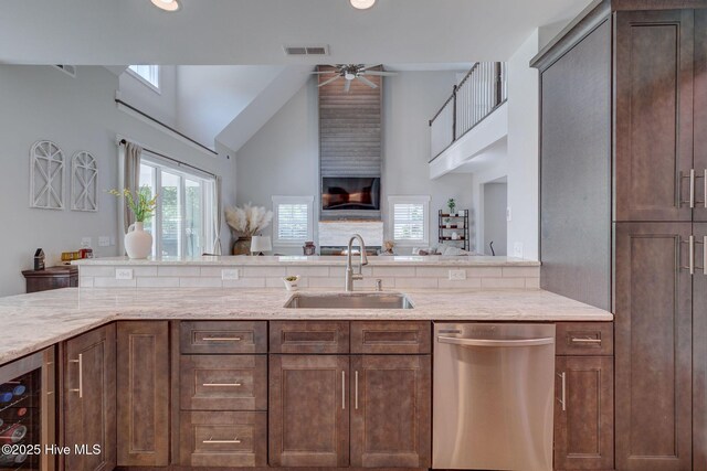 237 Pine Village Dr, Rocky Point, NC 28457 - kitchen featuring dishwasher, a ceiling fan, wine cooler, light stone counters, and high vaulted ceiling