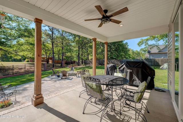 237 Pine Village Dr, Rocky Point, NC 28457 - fenced backyard featuring a patio, outdoor dining space, ceiling fan, a grill, and view of wooded area