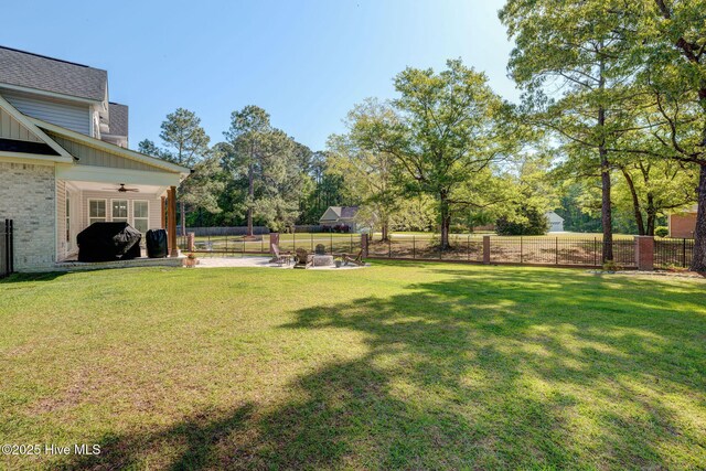 237 Pine Village Dr, Rocky Point, NC 28457 - fenced backyard featuring a ceiling fan and a patio
