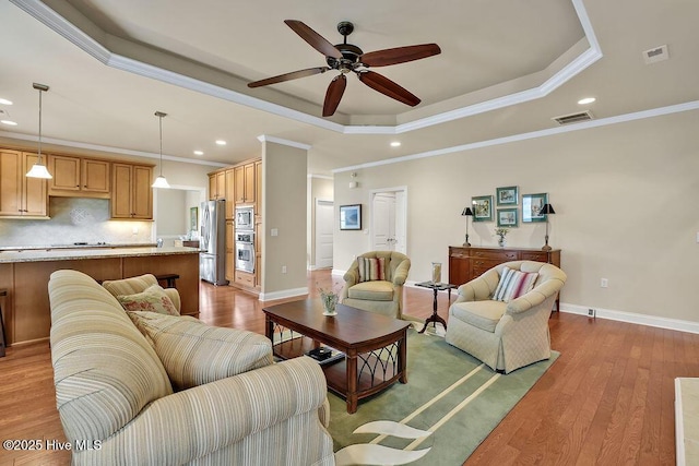 3284 Gardenwood Dr, Leland, NC 28451 - living room featuring a raised ceiling, recessed lighting, crown molding, ceiling fan, and wood finished floors
