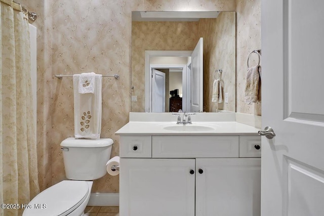 3284 Gardenwood Dr, Leland, NC 28451 - bathroom with toilet, vanity, wallpapered walls, tile patterned flooring, and baseboards