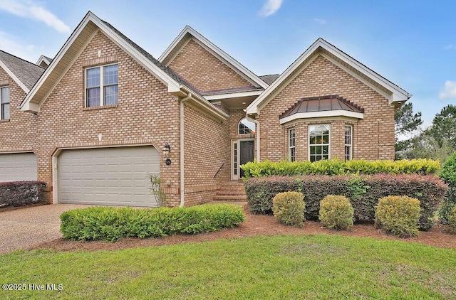 3284 Gardenwood Dr, Leland, NC 28451 - view of front facade with an attached garage, brick siding, a front yard, and driveway