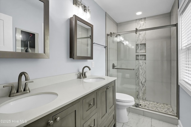 full bath featuring marble look tile flooring, a shower stall, toilet, and double vanity