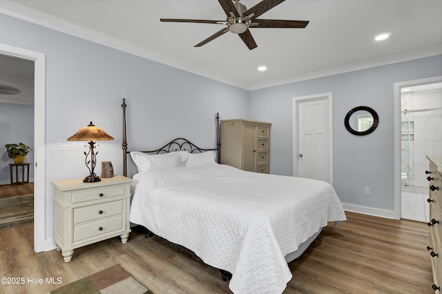 bedroom featuring baseboards, wood finished floors, ornamental molding, recessed lighting, and ensuite bath