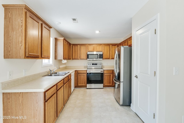 kitchen featuring a sink, light countertops, visible vents, and appliances with stainless steel finishes