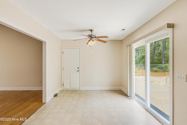 spare room with light floors, visible vents, baseboards, and ceiling fan