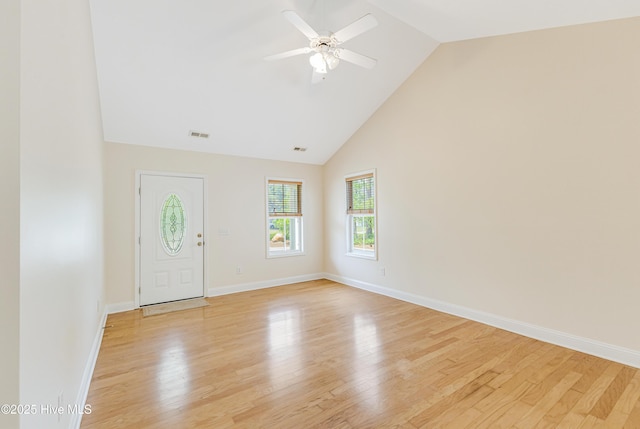 foyer entrance with high vaulted ceiling, ceiling fan, baseboards, and light wood-type flooring