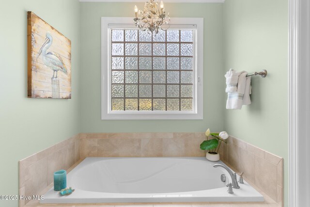 full bathroom featuring a chandelier and a bath