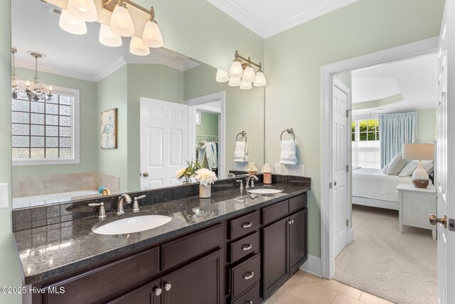 ensuite bathroom with a chandelier, plenty of natural light, tile patterned floors, ornamental molding, and baseboards