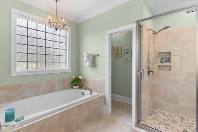 bathroom with a shower stall, a garden tub, crown molding, a chandelier, and baseboards